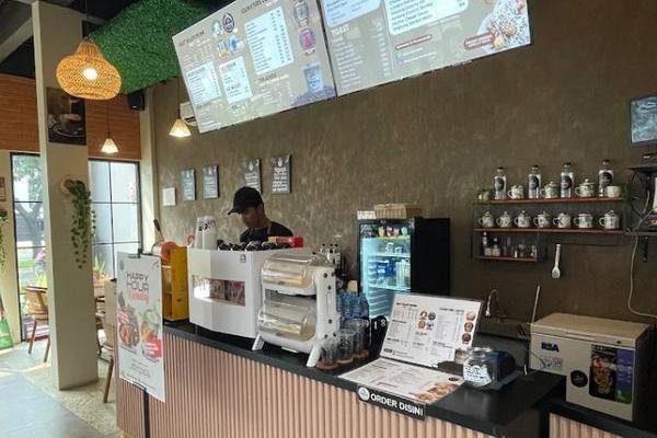 Bar station dan papan menu di dalam outlet Tentang Kopi